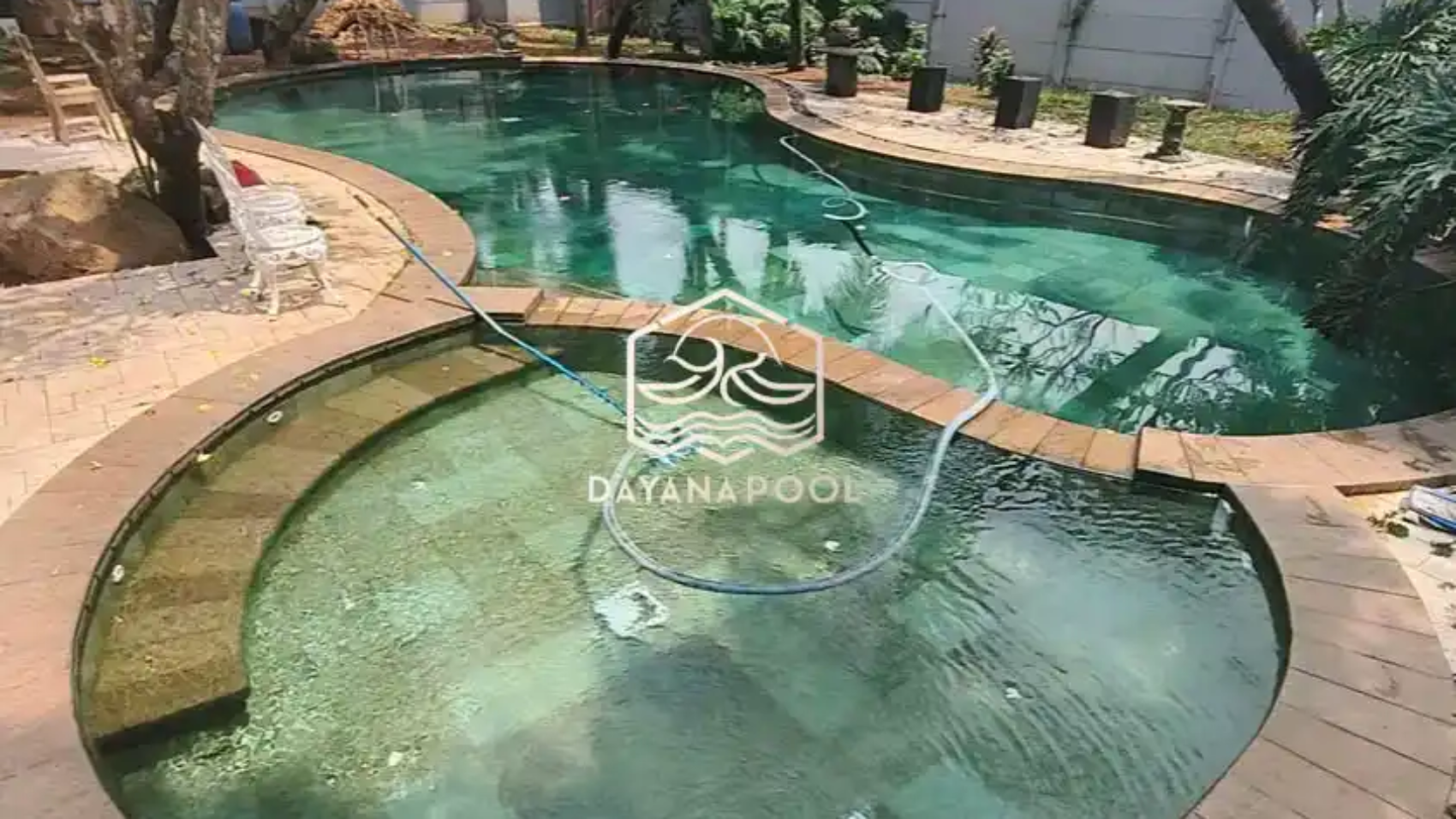 kolam renang oval yang indah dengan finidhing batu alam